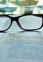 image of spectacles sitting on papers